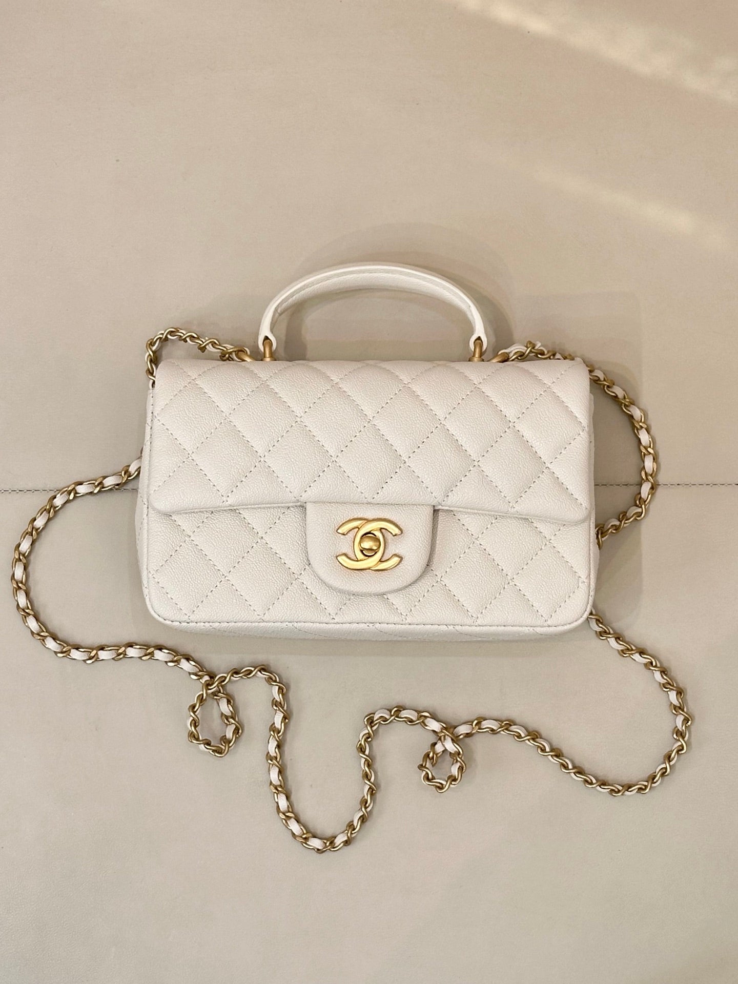 Chanel quilted mini flap bag, white with gold chain strap and front CC emblem