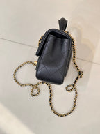 Chanel dark navy leather mini bag with gold chain strap, back side view