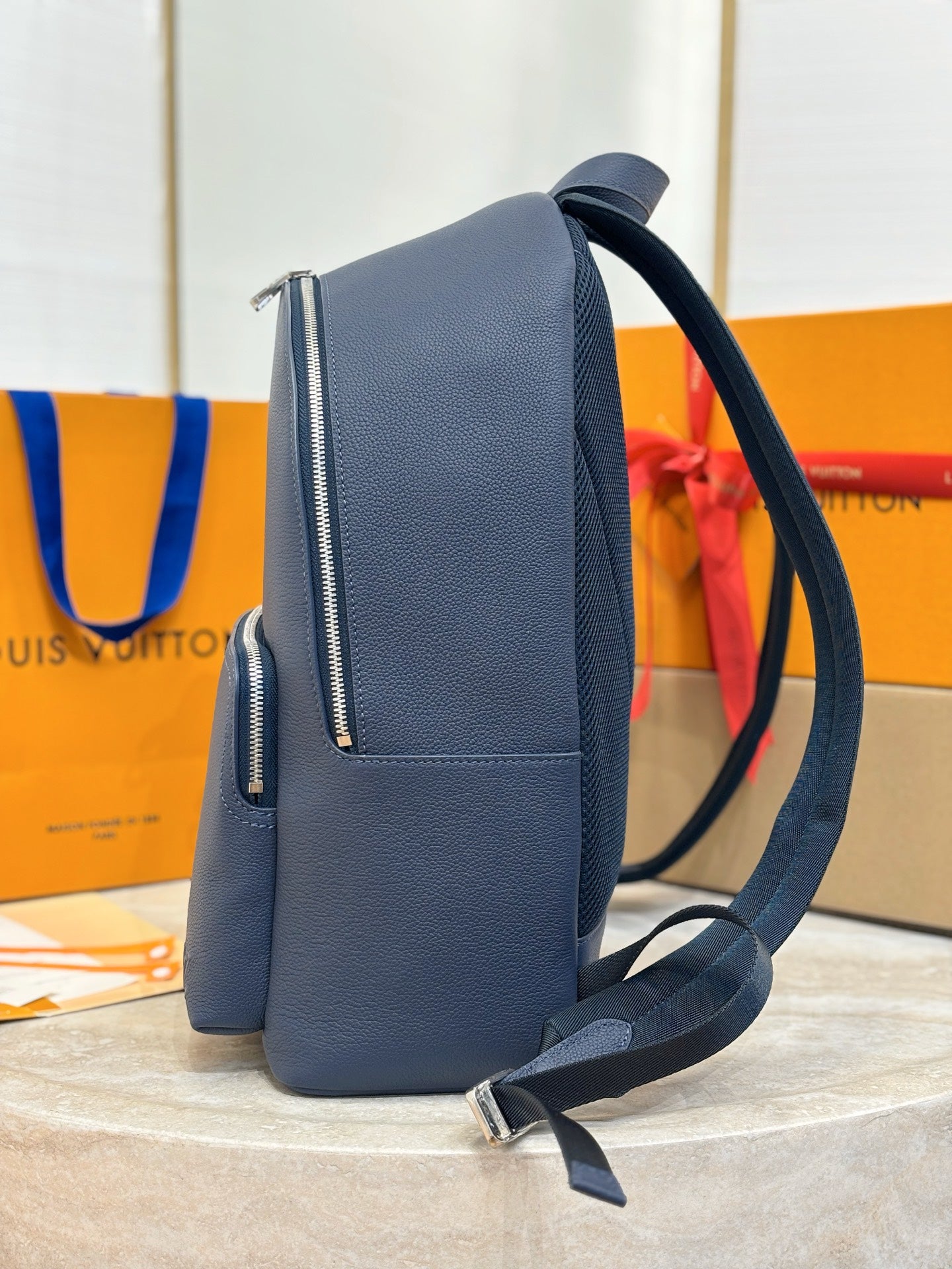 Louis Vuitton blue leather crossbody backpack with side zipper pocket