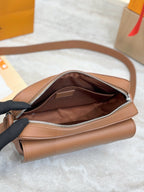 Tan leather Louis Vuitton crossbody bag with open top and zippered interior