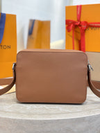 Tan leather Louis Vuitton crossbody bag from front view with flap and side buckles