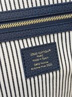 Louis Vuitton Paris label patch on striped interior lining of denim handbag