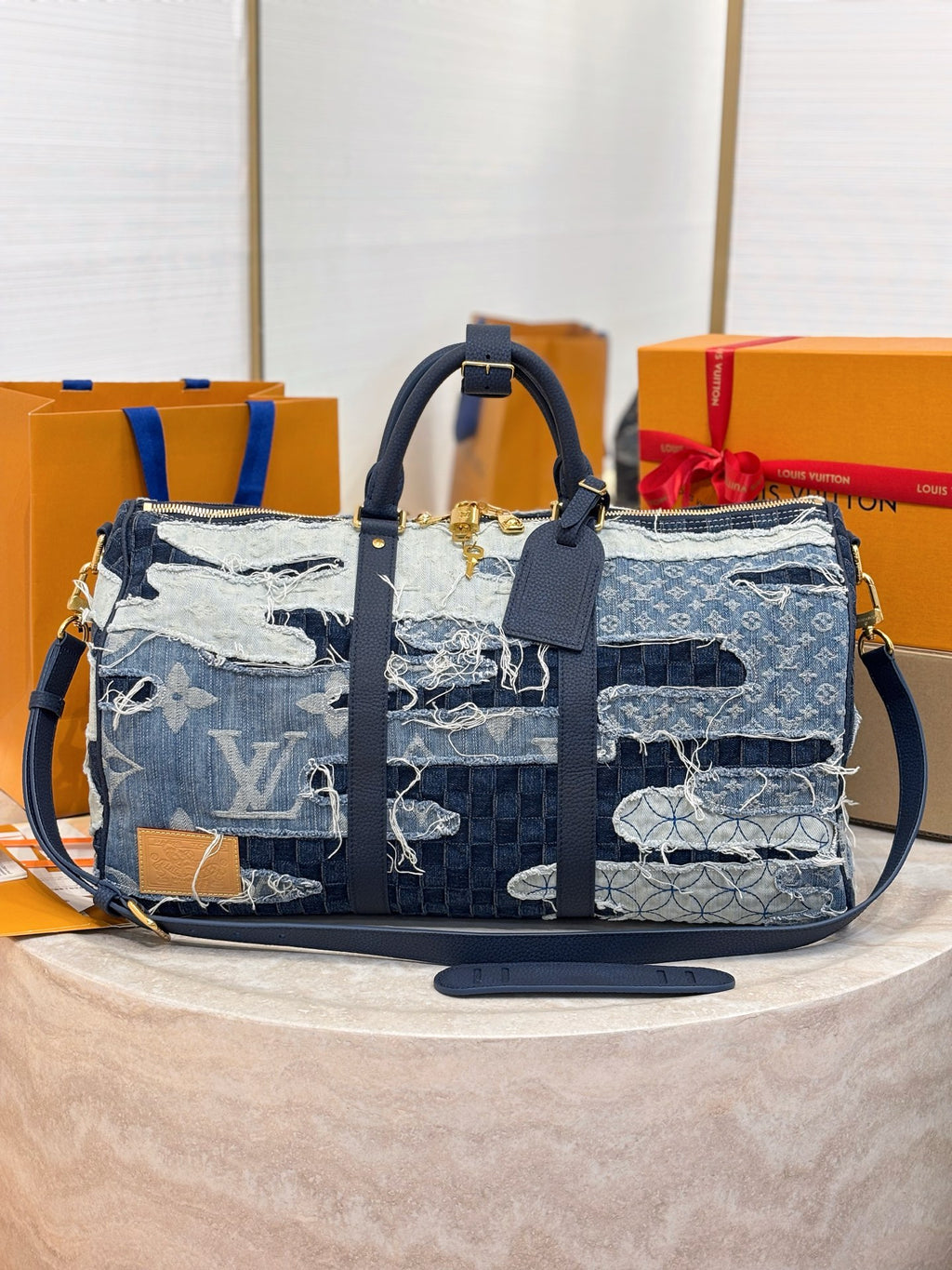 Louis Vuitton patchwork denim handbag with navy and light-blue panels, front straps