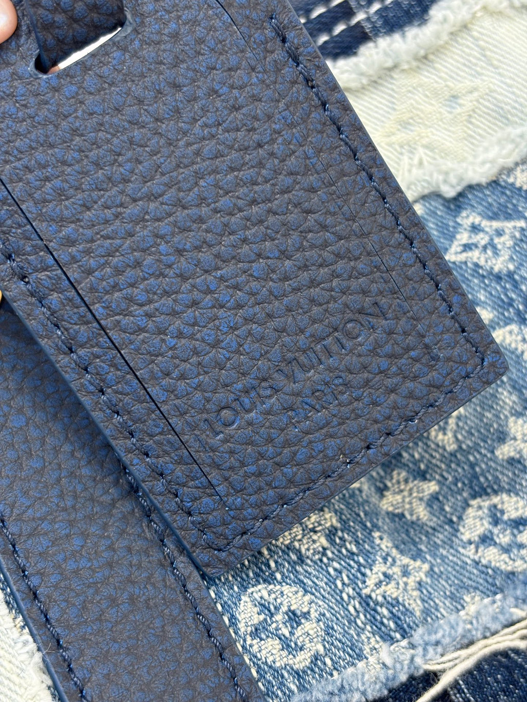 Louis Vuitton denim handbag close-up of textured blue strap and stitched panel