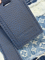 Louis Vuitton denim handbag close-up of textured blue strap and stitched panel