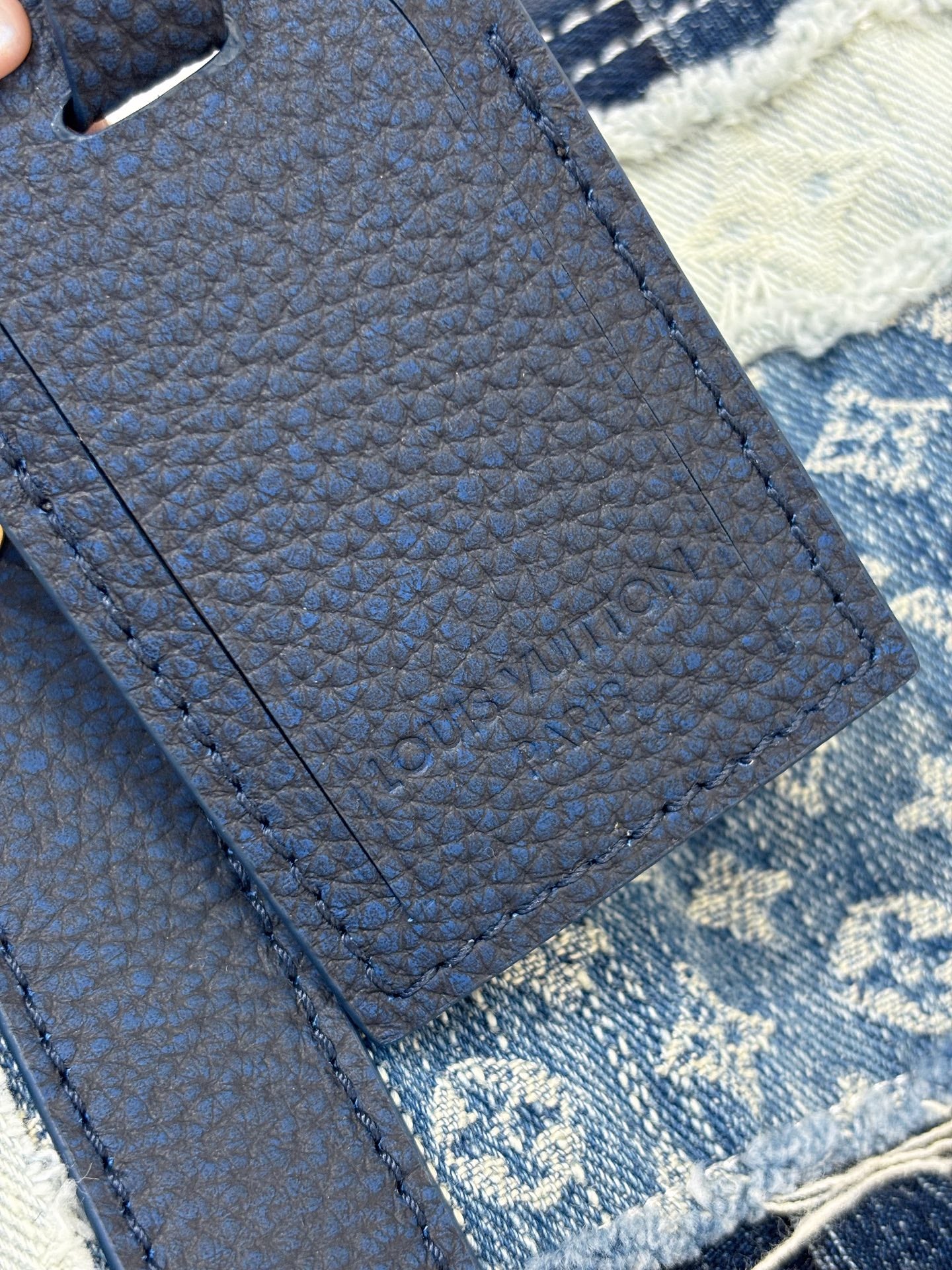 Louis Vuitton denim handbag close-up of textured blue strap and stitched panel