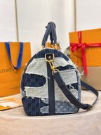 Louis Vuitton patchwork denim crossbody handbag with front strap and gold-tone buckle