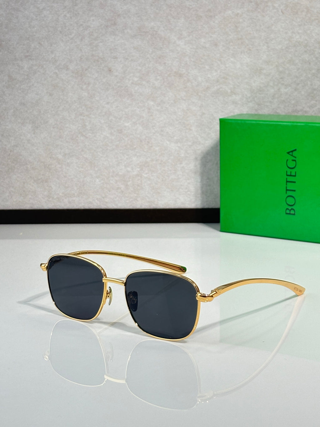 Gold-frame sunglasses with dark blue round lenses