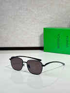 Black-frame sunglasses with dark round lenses