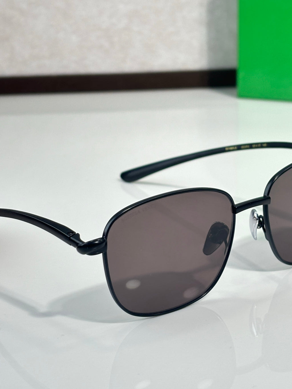 Black-frame sunglasses close-up with dark round lenses