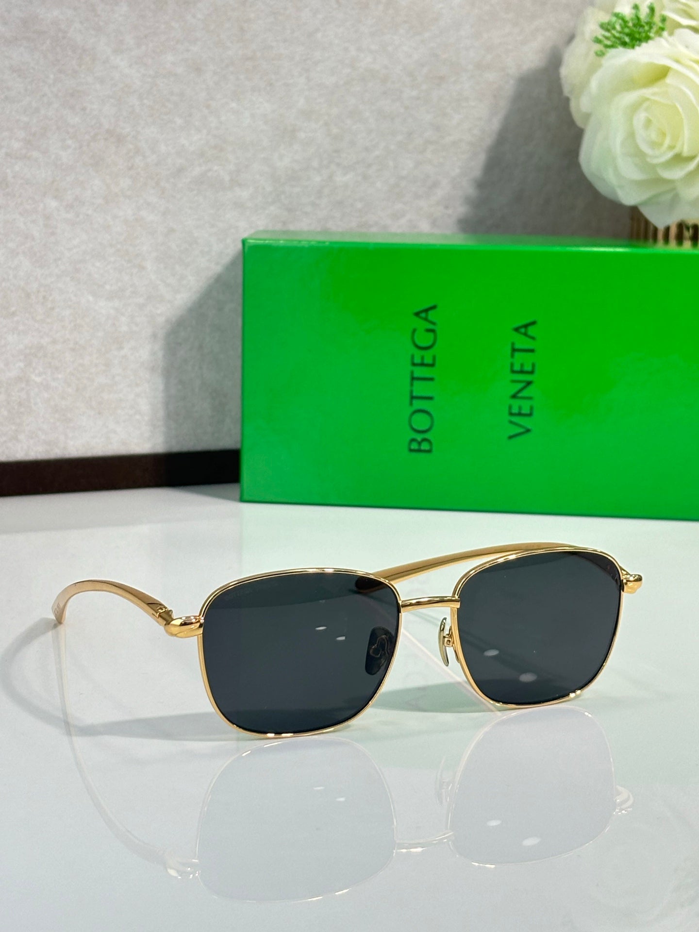Gold-frame sunglasses with dark round lenses and thin arms
