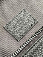 Stitched leather interior pocket with zipper teeth and textured grain