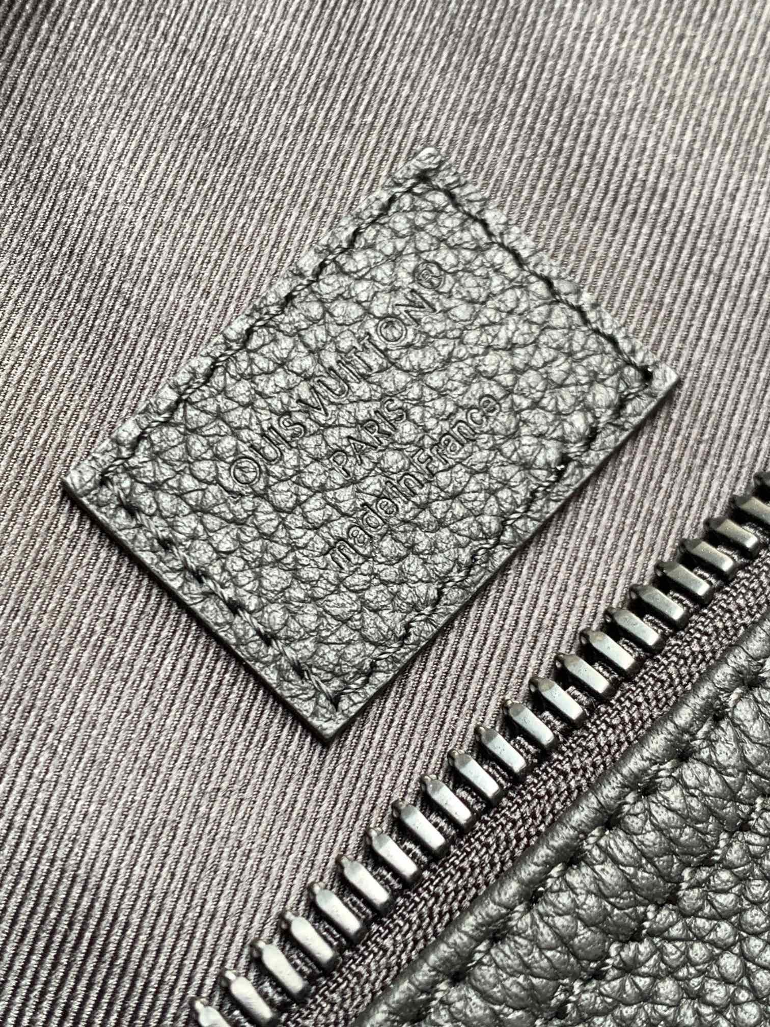 Stitched leather interior pocket with zipper teeth and textured grain