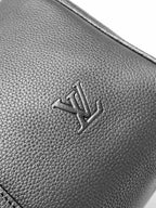 Textured dark leather panel with embossed Louis Vuitton logo