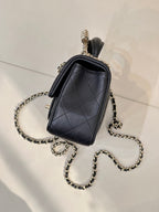 Dark small quilted leather crossbody bag with chain strap and top handle