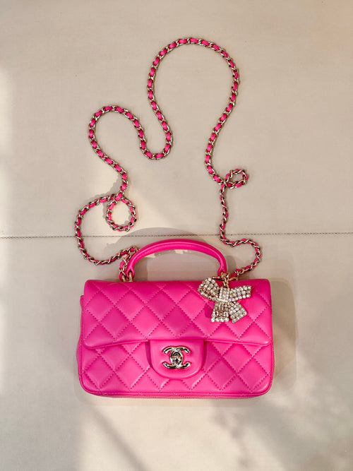 Chanel pink quilted mini bag with chain strap and rhinestone bow charm
