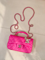 Chanel pink quilted shoulder bag with chain crossbody strap and bow accent