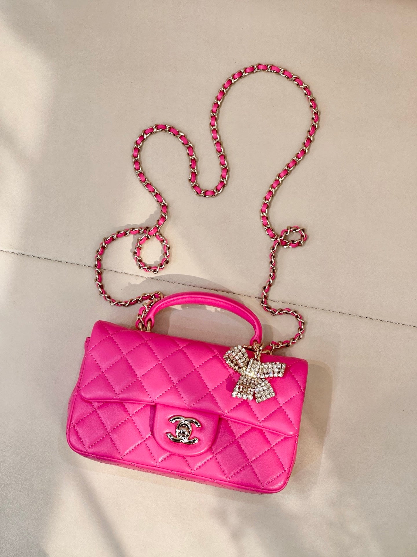 Chanel pink quilted shoulder bag with chain crossbody strap and bow accent