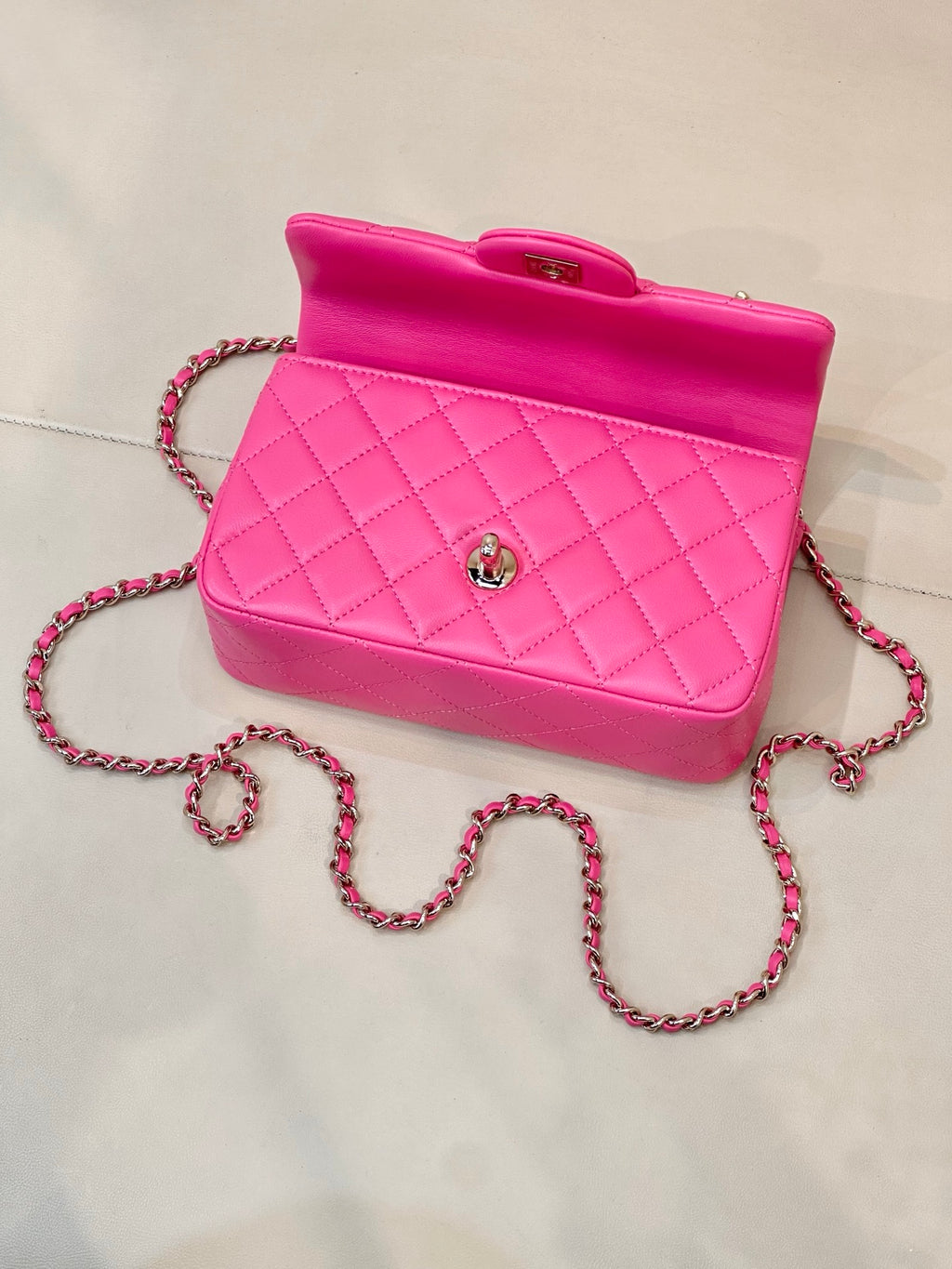 Chanel pink quilted mini bag with top handle and chain crossbody strap