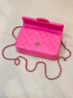 Chanel pink quilted mini bag with top handle and chain crossbody strap