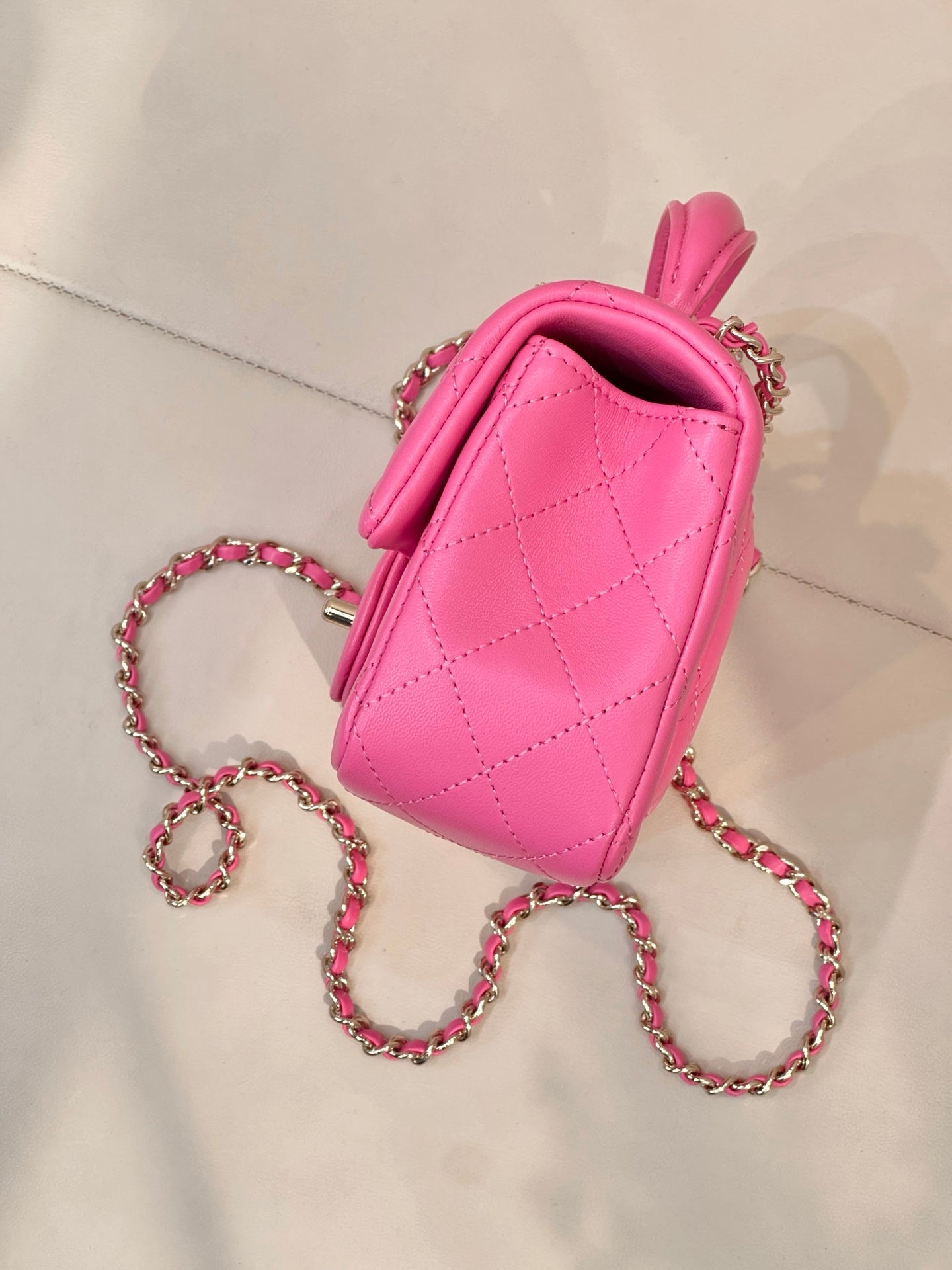 Chanel pink quilted mini bag with back view and chain crossbody strap