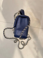 Quilted blue mini handbag with chain strap, side profile and gold-tone hardware