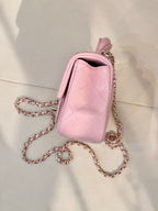 Chanel pink quilted flap crossbody bag with short handle, chain strap, and side view