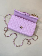 Quilted light purple handbag side view with open interior and chain shoulder strap