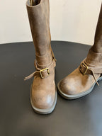 Suede ankle boots with buckle strap detail and cushioned white lug sole.