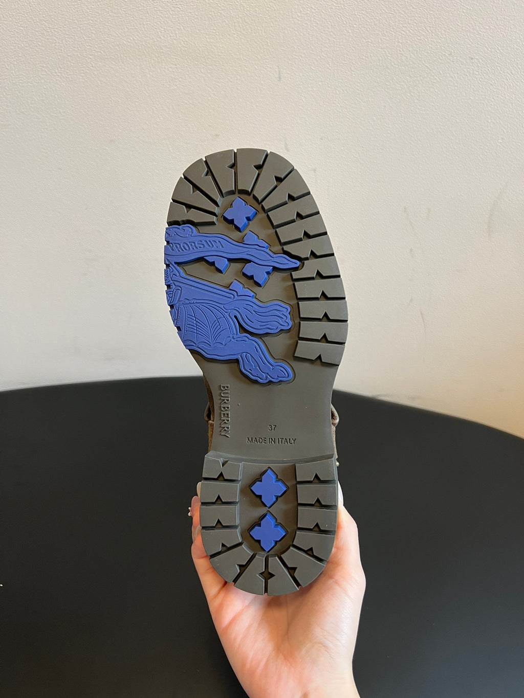 Boot outsole with patterned tread and blue graphic section under the heel.