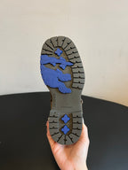 Boot outsole with patterned tread and blue graphic section under the heel.