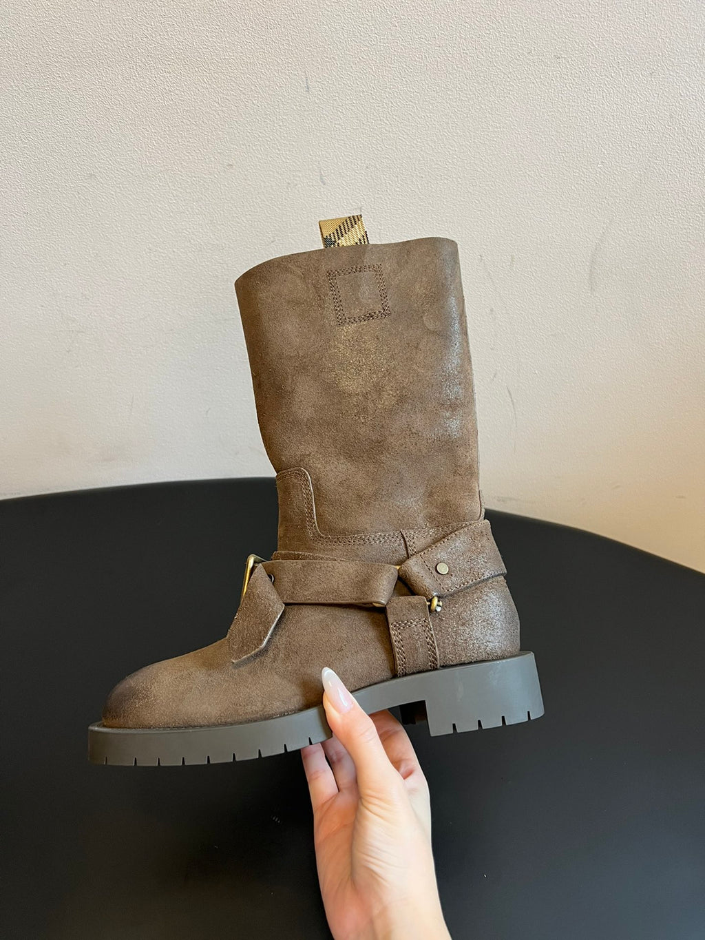 Suede ankle boots with side buckle strap and rugged white lug sole.