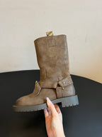 Suede ankle boots with side buckle strap and rugged white lug sole.
