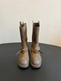 Suede ankle boots with side buckle straps and chunky white lug soles.
