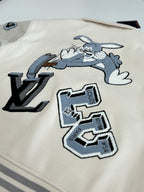 Cream long-sleeve jacket with LV monogram patch and blue graphic details