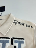 Louis Vuitton cream jacket collar with black script logo and blue letter patch