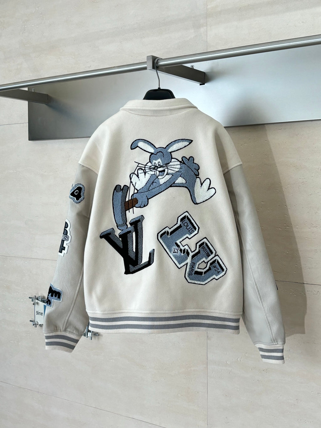 Louis Vuitton cream varsity-style jacket with blue cartoon and letter graphic on back