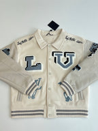 Louis Vuitton cream long-sleeve jacket with blue logo patches and ribbed knit cuffs