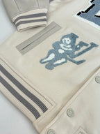 Louis Vuitton cream jacket hem with striped rib trim and blue cartoon patch