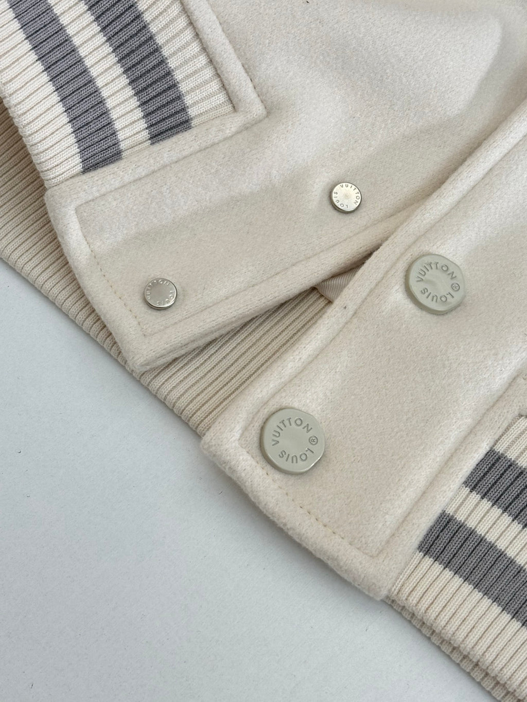 Louis Vuitton cream jacket bottom hem with striped rib panels and snap buttons