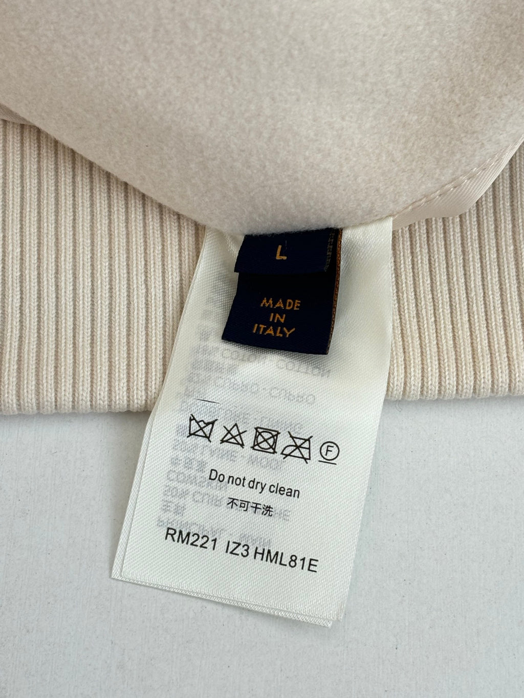 Garment size and care label with 'Made in Italy' and cleaning instructions