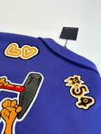 Blue long-sleeve sweatshirt with cartoon graphic patches on the chest