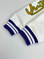 White long-sleeve sweatshirt cuff with blue-and-white striped rib knit