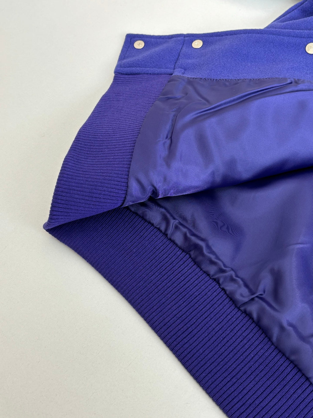 Blue track pants with ribbed waistband and smooth side panels