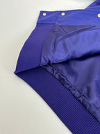 Blue track pants with ribbed waistband and smooth side panels