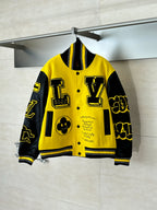 Louis Vuitton yellow and black varsity jacket with button front and bold graphic patches