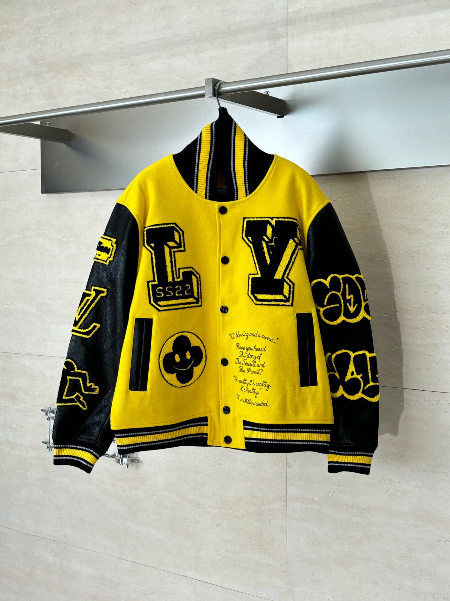 Louis Vuitton yellow and black varsity jacket with button front and bold graphic patches