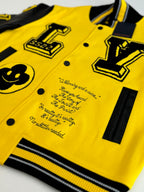 Louis Vuitton yellow and black varsity jacket front detail with embroidered script and button placket