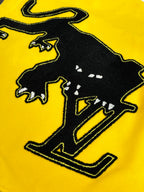 Louis Vuitton yellow and black varsity jacket graphic detail with silhouetted lettering patch