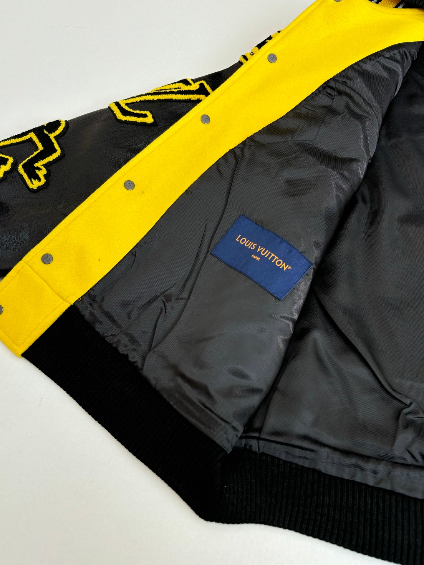 Yellow and black Louis Vuitton long jacket with blue interior logo patch
